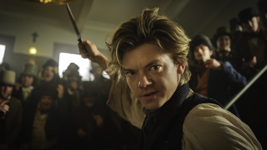 The Artful Dodger puts his hand in the air.